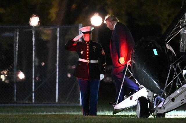 A Marine salutes as US President Donald Trump disembarks Marine One upon landing on the Ellipse near the White House in Washington, DC, on August 21, 2026. US President Donald Trump returns from South Carolina where he attended a campaign rally for US Senator Darline Graham. (Photo by Mandel NGAN / AFP)