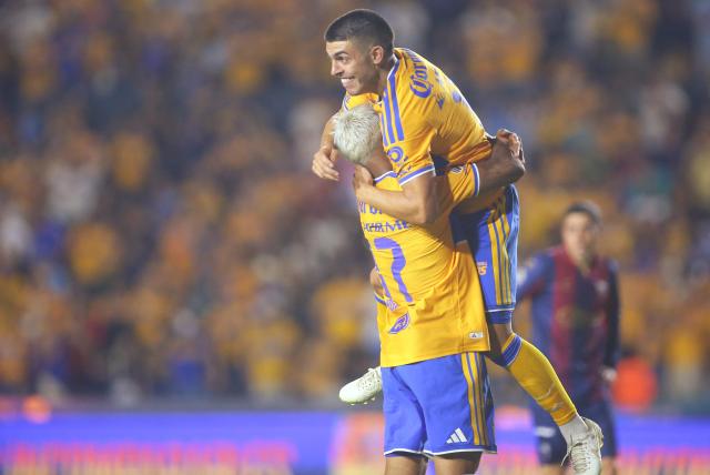 Tigres’ Uruguayan forward #17 Rodrigo Aguirre celebrates after scoring the opening goal with teammate Argentine midfielder #11 Juan Brunetta during the Liga MX Apertura football match between Tigres and Atlante at the Universitario stadium in San Nicolas de los Garza, Nuevo Leon, Mexico on August 21, 2026. (Photo by Julio Cesar AGUILAR / AFP)