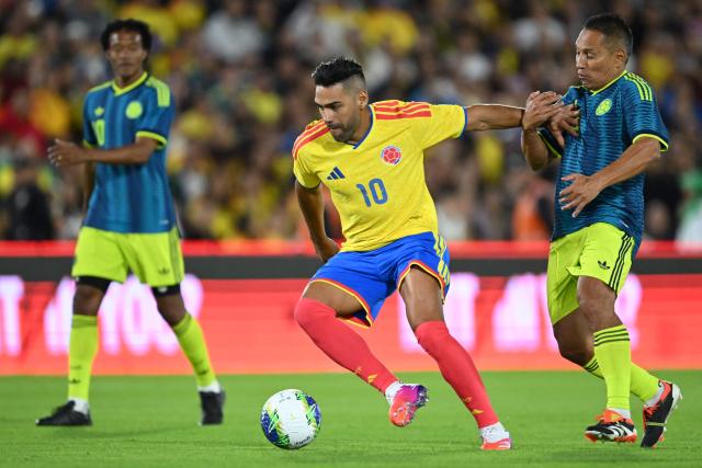 Colombian forward Radamel Falcao controls the ball next to former player John Restrepo during a football match to raise funds for the victims of an 7.4 earthquake, at El Campin stadium in Bogota on August 21, 2026. The powerful earthquake that killed hundreds of people in western Colombia caused $9.57 billion in economic losses, President Abelardo de la Espriella said on August 18, issuing a preliminary estimate. (Photo by Raul ARBOLEDA / AFP)