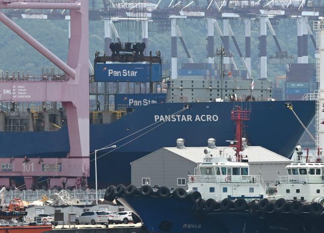 A container is loaded to the container ship "Panstar Acro" at Busan New Port in Busan on August 22, 2026, as the vessel is scheduled to sail to Europe via the Arctic to test the commercial viability of the shipping route opened by melting ice. South Korea was set on August 22, to send its first trial container through the Arctic, as the Middle East war rattles global shipping, while environmental groups warned the route could accelerate polar ice melt. (Photo by Jung Yeon-je / AFP)