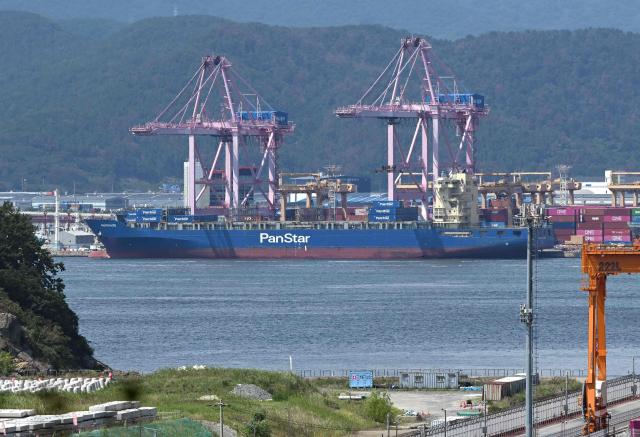 The container ship "Panstar Acro" is anchored to load containers at Busan New Port in Busan on August 22, 2026, as the vessel is scheduled to sail to Europe via the Arctic to test the commercial viability of the shipping route opened by melting ice. South Korea was set on August 22, to send its first trial container through the Arctic, as the Middle East war rattles global shipping, while environmental groups warned the route could accelerate polar ice melt. (Photo by Jung Yeon-je / AFP)