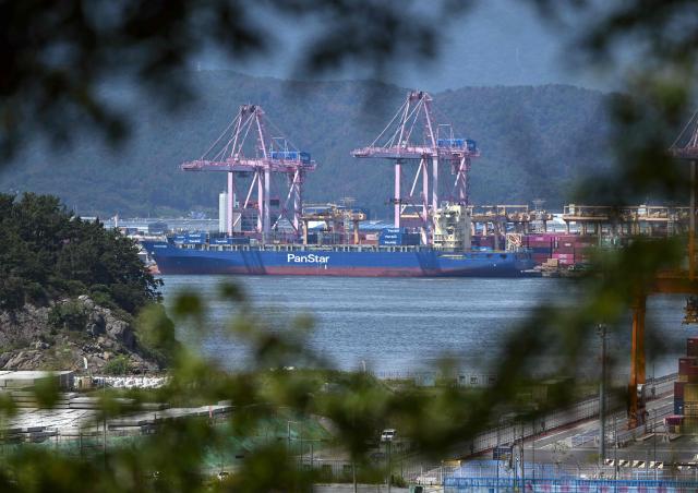 The container ship "Panstar Acro" is anchored to load containers at Busan New Port in Busan on August 22, 2026, as the vessel is scheduled to sail to Europe via the Arctic to test the commercial viability of the shipping route opened by melting ice. South Korea was set on August 22, to send its first trial container through the Arctic, as the Middle East war rattles global shipping, while environmental groups warned the route could accelerate polar ice melt. (Photo by Jung Yeon-je / AFP)