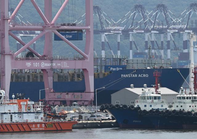 A container is loaded to the container ship "Panstar Acro" at Busan New Port in Busan on August 22, 2026, as the vessel is scheduled to sail to Europe via the Arctic to test the commercial viability of the shipping route opened by melting ice. South Korea was set on August 22, to send its first trial container through the Arctic, as the Middle East war rattles global shipping, while environmental groups warned the route could accelerate polar ice melt. (Photo by Jung Yeon-je / AFP)