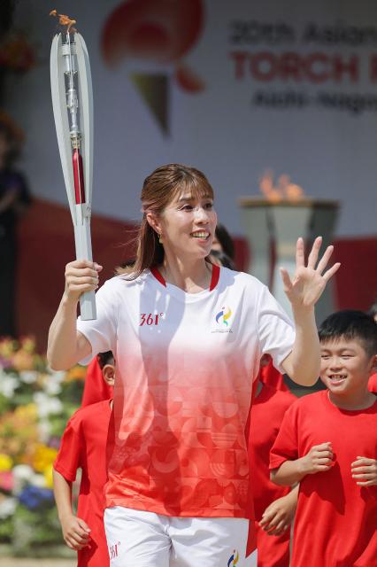 Japanese three-time Olympic wrestling gold medalist Saori Yoshida serves as the first torchbearer in the Aichi–Nagoya Asian Games torch relay in Nagoya city on August 22, 2026 (Photo by JIJI Press / AFP) / Japan OUT