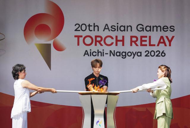 (From L to R) Former professional women’s tennis player Kimiko Date, member of the Japanese boy group INI Takeru Goto and former Japanese women’s national football team player Homare Sawa attend the flame-lighting ceremony for the Aichi-Nagoya Asian Games in Nagoya city on August 22, 2026. (Photo by JIJI Press / AFP) / Japan OUT
