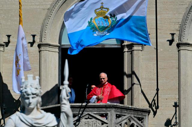 Pope Leo XIV greets the crowd from the balcony of the Public Palace during a pastoral visit to San Marino, on August 22, 2026. (Photo by Stefano RELLANDINI / AFP)