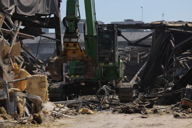 A heavy machinery works at the site of a shopping mall damaged following a Russian strike in Kryvyi Rih, on August 22, 2026, amid the Russian invasion of Ukraine. Russian drones slammed into a busy shopping centre in eastern Ukraine on August 21, killing 16 people in an attack condemned as "cynical and despicable" by President Volodymyr Zelensky. (Photo by Yan Dobronosov / AFP)