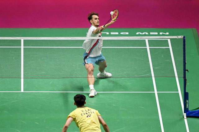 France's Alex Lanier (R) hits a return to Canada's Victor Lai during the BWF World Championships men's singles semi-final badminton match at the Indira Gandhi Indoor Stadium in New Delhi on August 22, 2026. (Photo by Arun SANKAR / AFP)