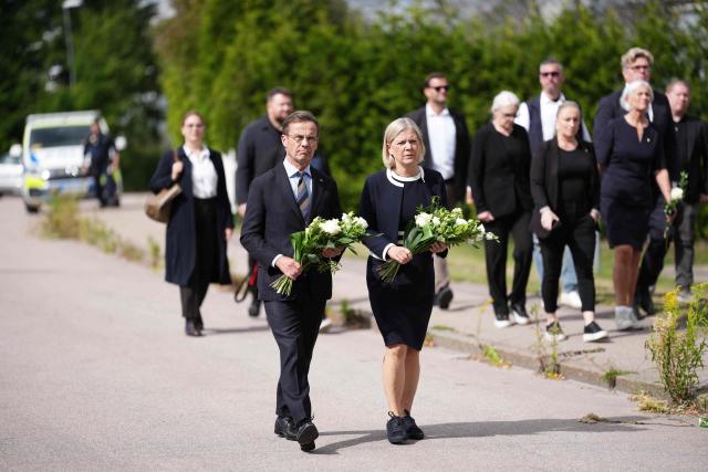 Swedish Prime Minister Ulf Kristersson and Social Democratic Party leader Magdalena Andersson visit the makeshift memorial outside a school in Fagersta, central Sweden, on August 22, 2026, a day after a 17-year-old girl was killed and three other people were injured in a sword attack at the school. Police said the suspect was an 18-year-old man who was shot and taken into custody on suspicion of murder. (Photo by Magnus LEJHALL / TT NEWS AGENCY / AFP) / Sweden OUT