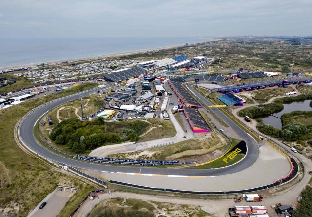 (FILES) This aerial photograph shows a view of the Circuit Zandvoort, western Netherlands, ahead of the Formula One Dutch Grand Prix in Zandvoort on August 26, 2025. For three days a year, the quiet residential street of Van Speijkstraat in the sleepy Dutch beach resort of Zandvoort transforms itself into a sea of orange streamers and chequered flags, welcoming Formula One fans from around the world. (Photo by Robin van Lonkhuijsen / ANP / AFP) / Netherlands OUT