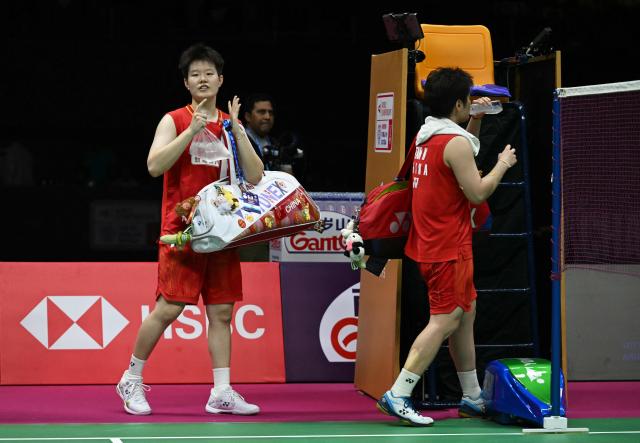 China's Liu Sheng Shu (L) and Tan Ning (R) leave the court after winning against India's Gayatri Gopichand Pullela and Treesa Jolly during the BWF World Championships women's doubles semi-final badminton match at the Indira Gandhi Indoor Stadium in New Delhi on August 22, 2026. (Photo by Arun SANKAR / AFP)