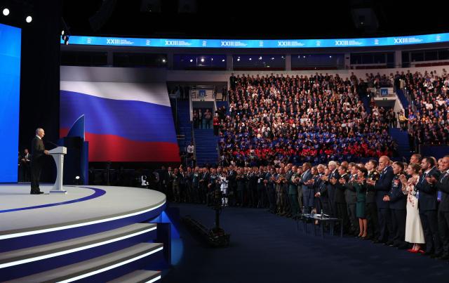 EDITORS NOTE: Graphic content / In this pool photograph distributed by the Russian state agency Sputnik, Russian President Vladimir Putin (L) speaks at the second stage of the 23rd Congress of the United Russia party at the Megasport Arena in Moscow on August 22, 2026. (Photo by Yekaterina SHTUKINA / POOL / AFP)