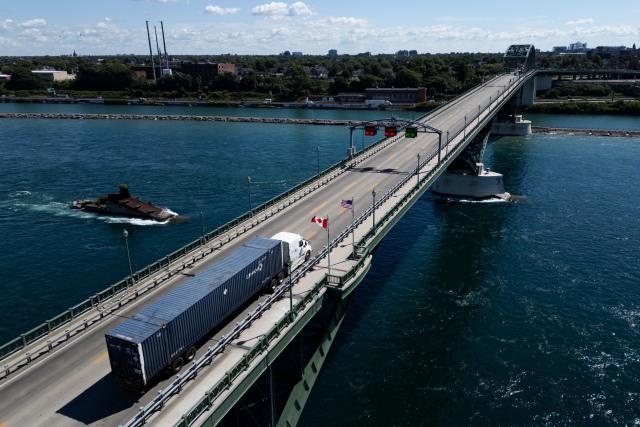 (FILES) A truck passes over the Peace Bridge between Canada and the United States, in Fort Erie, Ontario, on August 18, 2026. Hefty US tariffs on some Canadian products took effect on August 22, 2026 after days of negotiations that went down to the wire failed to produce an agreement. Canadian Prime Minister Mark Carney vowed that his country will match the US tariffs "dollar for dollar to protect our workers and businesses," as officials said late Friday that Washington and Ottawa had not managed to strike a deal. (Photo by Cole BURSTON / AFP)