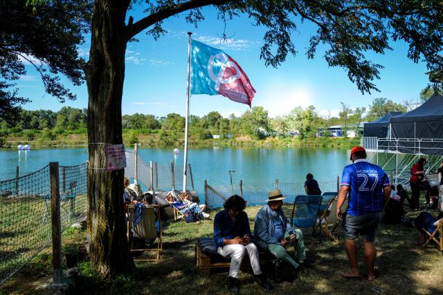 People take part in the 'Amfis' party Summer Conferences 'Universites d'ete' (Summer Seminars) of the French left wing party La France Insoumise (LFI) in Chateauneuf-sur-Isere, southeastern France, on August 22, 2026. (Photo by OLIVIER CHASSIGNOLE / AFP)