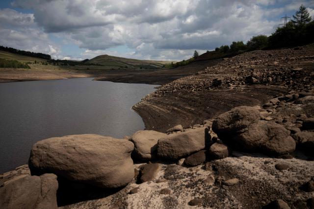 The partially revealed bed of Woodhead Reservoir following a falling water level, near Glossop, northern England on August 22, 2026. Nearly three quarters of England has been classified as in drought after the driest July on record. (Photo by Oli SCARFF / AFP)