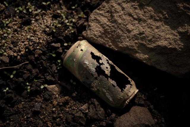 An eroded discarded drinks scan lies on the partially revealed bed of Woodhead Reservoir following a falling water level, near Glossop, northern England on August 22, 2026. Nearly three quarters of England has been classified as in drought after the driest July on record. (Photo by Oli SCARFF / AFP)