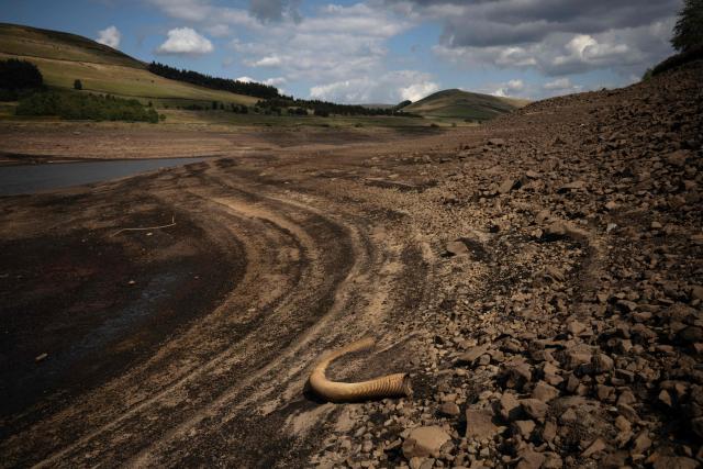 The partially revealed bed of Woodhead Reservoir following a falling water level, near Glossop, northern England on August 22, 2026. Nearly three quarters of England has been classified as in drought after the driest July on record. (Photo by Oli SCARFF / AFP)