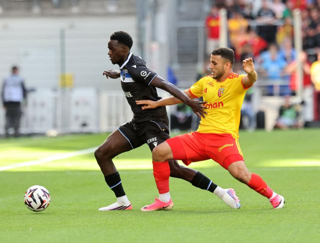 Lens' Malian midfielder #08 Mamadou Sangare (L) and Auxerre's French midfielder #08 Nathan Buayi-Kiala fight for the ball during the French L1 football match between RC Lens and AJ Auxerre at the Stade Bollaert-Delelis in Lens, northern France on August 22, 2026. (Photo by Francois LO PRESTI / AFP)