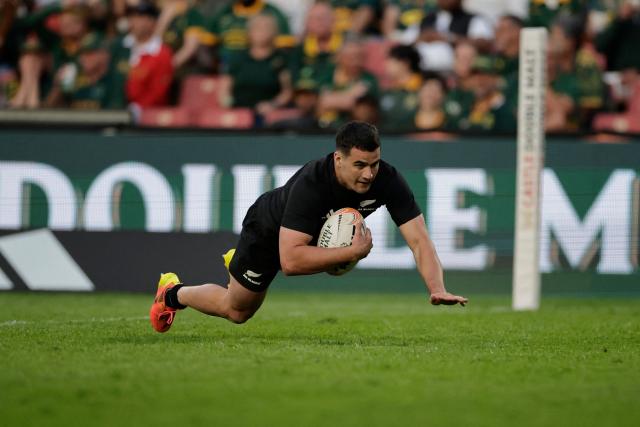 TOPSHOT - New Zealand's wing Josh Moorby dives to score a try during the Rugby's Greatest Rivalry international rugby union match between South Africa and New Zealand at Ellis Park Stadium in Johannesburg, on August 22, 2026. (Photo by PHILL MAGAKOE / AFP)