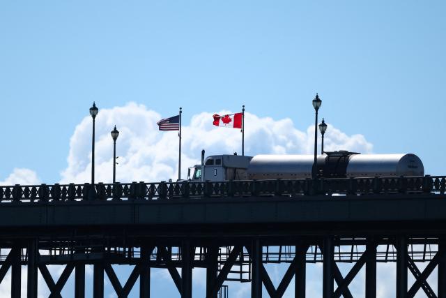 (FILES) A truck passes over the Peace Bridge from Buffalo, New York, into Canada, in Fort Erie, Ontario, on August 18, 2026. Hefty US tariffs on some Canadian products took effect on August 22, 2026 after days of negotiations that went down to the wire failed to produce an agreement. Canadian Prime Minister Mark Carney vowed that his country will match the US tariffs "dollar for dollar to protect our workers and businesses," as officials said late Friday that Washington and Ottawa had not managed to strike a deal. (Photo by Cole BURSTON / AFP)