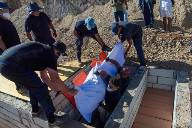 An unidentified migrant who drowned while trying to swim to the Spanish coast of Ceuta from the Moroccan coast is buried in Ceuta, on August 22, 2026. Some 72,000 migrants breached the border in an unprecedented and deadly rush into the north African territory on July 30-31, with 70,000 having since returned to Morocco, according to Spanish government figures. (Photo by Antonio Sempere / AFP)