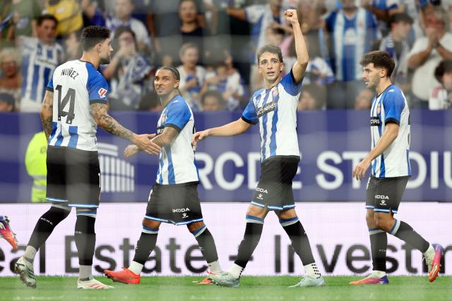 Espanyol's Spanish midfielder #22 Alex Calatrava (2R) celebrates scoring a goal during the Spanish league football match between RCD Espanyol and Real Madrid CF at RCDE Stadium in Cornella de Llobregat on August 22, 2026. (Photo by Josep LAGO / AFP)