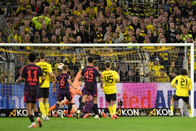 Dortmund's Portuguese forward #21 Fabio Silva (R) scores the 1-2 goal against Bayern Munich's German goalkeeper #01 Manuel Neuer (C, hidden) during the Franz Beckenbauer Supercup football match between Borussia Dortmund and FC Bayern Munich on August 22, 2026 in Dortmund, western Germany. (Photo by INA FASSBENDER / AFP) / DFL REGULATIONS PROHIBIT ANY USE OF PHOTOGRAPHS AS IMAGE SEQUENCES AND/OR QUASI-VIDEO