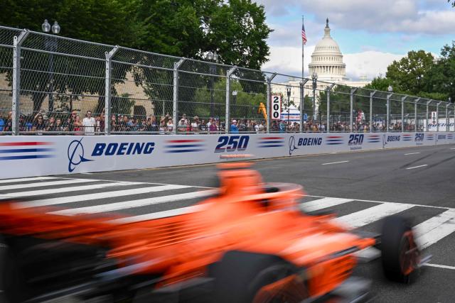 Indy Cars race down a street leading to the Capitol Building during a qualification round in Washington, DC, on August 22, 2026, on the eve of the Freedom Grand Prix. The Freedom 250 Grand Prix, held Sunday, August 23, in Washington, DC, is part of celebrations marking the 250th anniversary of US independence. The race will cover 147 laps of a 1.7-mile, seven-turn street circuit around the National Mall, passing landmarks including the US Capitol and Washington Monument. (Photo by ROBERTO SCHMIDT / AFP)