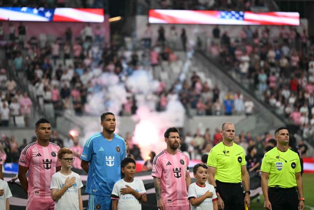 (L/R) Inter Miami's Brazilian defender #05 Casemiro, Canadian goalkeeper #97 Dayne St. Clair and Argentine forward #10 Lionel Messi stand for the National Anthem ahead of the Major League Soccer (MLS) regular season football match between Inter Miami CF and Toronto FC at Nu Stadium in Miami, Florida, on August 22, 2026. (Photo by CHANDAN KHANNA / AFP)