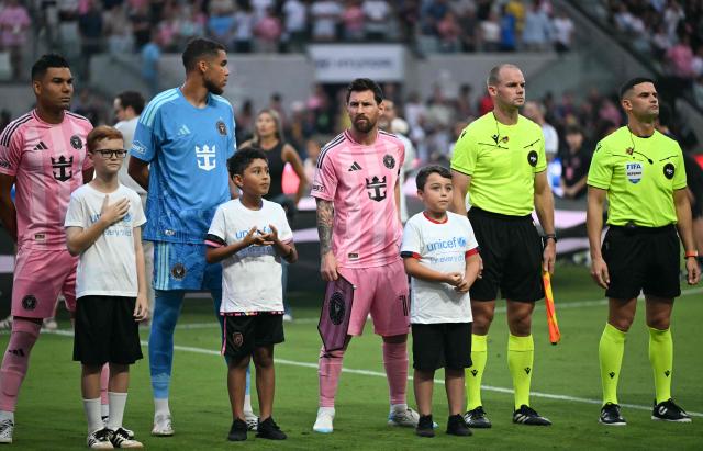 (L/R) Inter Miami's Brazilian defender #05 Casemiro, Canadian goalkeeper #97 Dayne St. Clair and Argentine forward #10 Lionel Messi stand for the National Anthem ahead of the Major League Soccer (MLS) regular season football match between Inter Miami CF and Toronto FC at Nu Stadium in Miami, Florida, on August 22, 2026. (Photo by CHANDAN KHANNA / AFP)