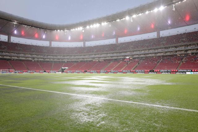 Rain falls on the pitch at the Akron stadium delaying the Liga MX Apertura football match between Guadalajara and Tijuana in Zapopan, Jalisco, Mexico on August 22, 2026. (Photo by ULISES RUIZ / AFP)