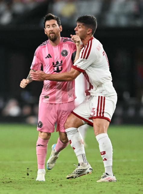 Toronto's Chilean defender #13 Benjamín Kuscevic pushes Inter Miami's Argentine forward #10 Lionel Messi during the Major League Soccer (MLS) regular season football match between Inter Miami CF and Toronto FC at Nu Stadium in Miami, Florida, on August 22, 2026. (Photo by CHANDAN KHANNA / AFP)
