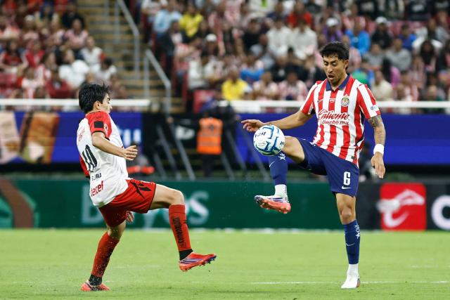 Guadalajara's midfielder #06 Omar Govea (R) controls the ball past Tijuana's midfielder #10 Gilberto Mora during the Liga MX Apertura football match between Guadalajara and Tijuana at the Akron stadium in Zapopan, Jalisco, Mexico on August 22, 2026. (Photo by ULISES RUIZ / AFP)