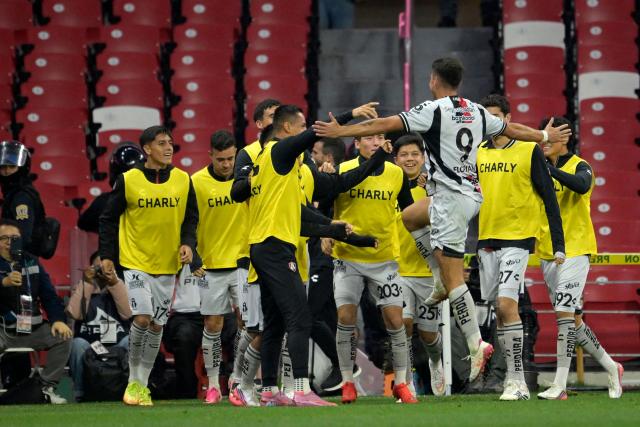 Atlas' Argentine forward #09 Florian Monzon celebrates scoring his team's second goal with teammates during the Liga MX Apertura football match between Cruz Azul and Atlas at the Ciudad de los Deportes Stadium in Mexico City on August 22, 2026. (Photo by Alfredo ESTRELLA / AFP)