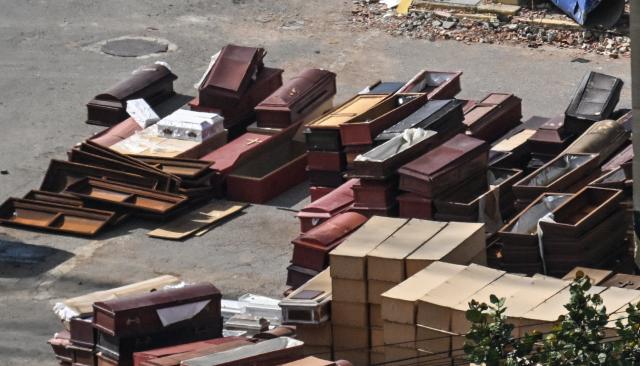 Empty coffins are accumulated at a makeshift morgue in La Guaira, Venezuela on August 22, 2026. Venezuela has recorded 6,438 deaths nearly two months after the consecutive 7.2 and 7.5 earthquakes that struck the country on June 24, 2026, while the search for bodies continues amid the rubble and the demolition of damaged buildings. (Photo by Juan BARRETO / AFP)