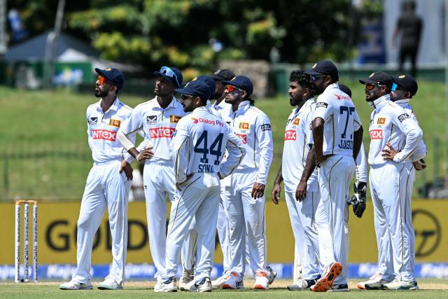 Sri Lanka's players watch the big screen as they wait for a DRS (decision review system) appeal against India's Yashasvi Jaiswal during the first day of the second Test cricket match between Sri Lanka and India at the Sinhalese Sports Club Ground in Colombo on August 23, 2026. (Photo by Ishara S. KODIKARA / AFP)