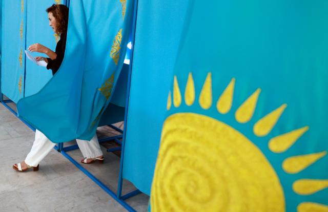 A woman leaves the polling booth to cast her ballot at a polling station during parliamentary elections, in Almaty, southeastern Kazakhstan on August 23, 2026. Ex-Soviet Kazakhstan votes for a new unicameral parliament following changes to its constitution that authorities say will democratise Central Asia's largest economy, but critics slam the move as cementing the president's power. (Photo by Ruslan PRYANIKOV / AFP)