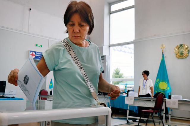 A woman casts her ballot at a polling station during parliamentary elections, in Almaty, southeastern Kazakhstan on August 23, 2026. Ex-Soviet Kazakhstan votes for a new unicameral parliament following changes to its constitution that authorities say will democratise Central Asia's largest economy, but critics slam the move as cementing the president's power. (Photo by Ruslan PRYANIKOV / AFP)