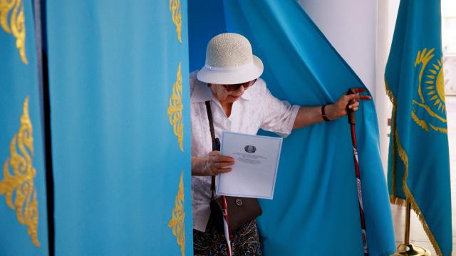 A woman leaves the polling booth to cast her ballot at a polling station during parliamentary elections, in Almaty, southeastern Kazakhstan on August 23, 2026. Ex-Soviet Kazakhstan votes for a new unicameral parliament following changes to its constitution that authorities say will democratise Central Asia's largest economy, but critics slam the move as cementing the president's power. (Photo by Ruslan PRYANIKOV / AFP)