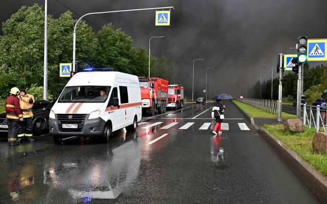 Smoke rises over a logistics center in Kolpino, outside Saint Petersburg after being hit by Ukrainian drones early on August 23, 2026. (Photo by AFP)