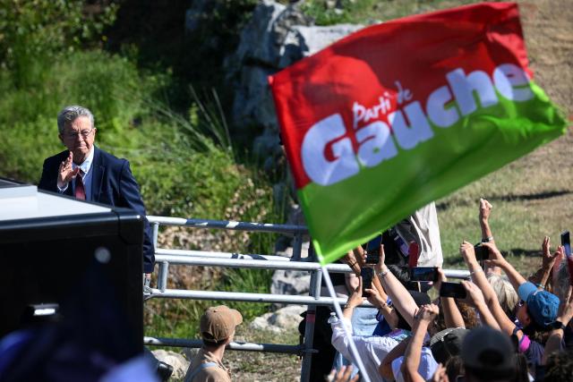 French left-wing party La France Insoumise (LFI) founder and presidential election candidate Jean-Luc Melenchon (L) arrives to delivers a speech during the 'Amfis' party Summer Conferences 'Universites d'ete' (Summer Seminars) of the LFI party in Chateauneuf-sur-Isere, southeastern France on August 23, 2026. (Photo by OLIVIER CHASSIGNOLE / AFP)