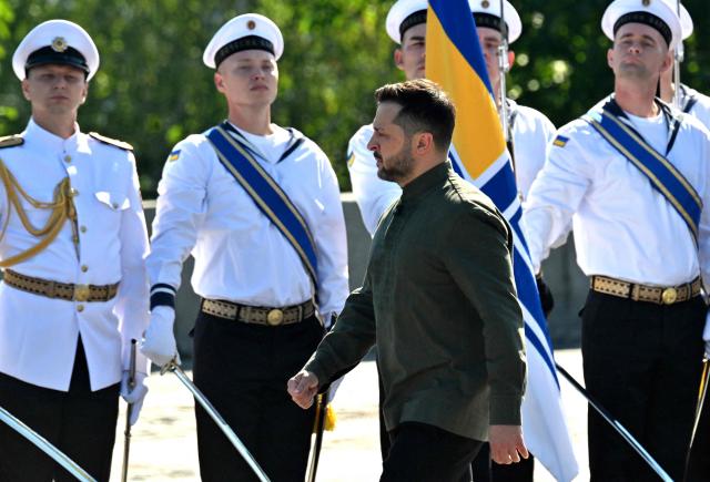 Ukraine's President Volodymyr Zelensky walks in front of the guard of honor during a ceremony marking the National Flag Day of Ukraine in Kyiv on August 23, 2026, amid Russian invaion of Ukraine. Zelensky said in remarks made public on August 23, 2026 that it would be too dangerous for Ukraine to hold an election while it fights Russia's invasion, after a call by his former defence minister to organise a vote. (Photo by Sergei SUPINSKY / AFP)