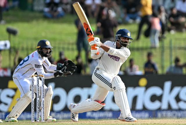 India's Ravindra Jadeja (R) plays a shot as Sri Lanka's wicketkeeper Niroshan Dickwella watches during the first day of the second Test cricket match between Sri Lanka and India at the Sinhalese Sports Club Ground in Colombo on August 23, 2026. (Photo by Ishara S. KODIKARA / AFP)