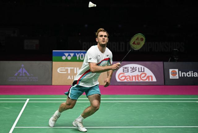 France's Alex Lanier eyes a return against Japan's Kodai Naraoka during the BWF World Championships men's singles final badminton match at the Indira Gandhi Indoor Stadium in New Delhi on August 23, 2026. (Photo by Sajjad HUSSAIN / AFP)
