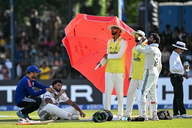 India's Devdutt Padikkal (2L) and Ravindra Jadeja (2R) rest during a drinks break on the first day of the second Test cricket match between Sri Lanka and India at the Sinhalese Sports Club Ground in Colombo on August 23, 2026. (Photo by Ishara S. KODIKARA / AFP)
