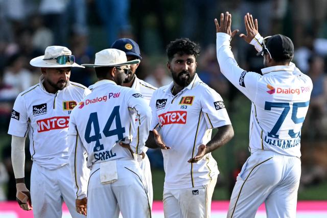 Sri Lanka's Asitha Fernando (2R) celebrates with teammates after taking the wicket of India's Ravindra Jadeja during the first day of the second Test cricket match between Sri Lanka and India at the Sinhalese Sports Club Ground in Colombo on August 23, 2026. (Photo by Ishara S. KODIKARA / AFP)