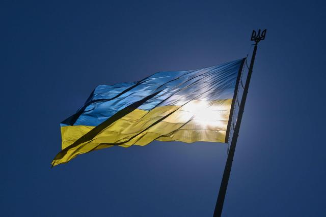 This photograph shows the biggest national flag in the country on a flagpole in front of Motherland Monument during a ceremony marking the National Flag Day of Ukraine in Kyiv on August 23, 2026, amid Russian invasion of Ukraine. (Photo by Sergei SUPINSKY / AFP)