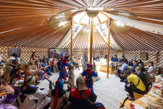 Delegates attend the "Nomads" World Cultural Festival at the foot of Taij Khairkhan mountain in Nalaikh district on the outskirts of Ulaanbaatar on August 23, 2026. (Photo by Byambasuren BYAMBA-OCHIR / AFP)