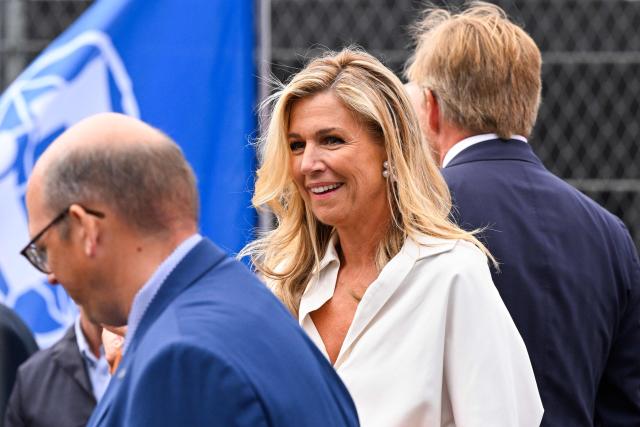 (From L) Italian motorsport executive President and CEO of Formula 1 Stefano Domenicali, Netherlands' Queen Máxima and Netherlands' King Willem-Alexander walk ahead of the Formula One Dutch Grand Prix at The Circuit Zandvoort, western Netherlands, on August 23, 2026. (Photo by JOHN THYS / AFP)
