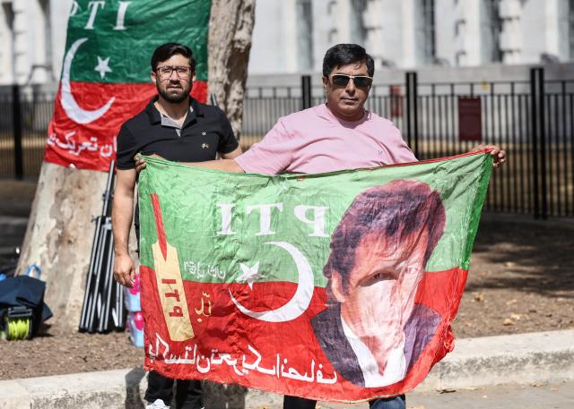 Supporters of Pakistan's jailed former prime minister Imran Khan hold a rally opposite Downing Street in central London on August 23, 2026. The ex-cricket captain, who was prime minister from 2018 to 2022, was sentenced along with his wife in late 2025 to 17 years in prison in a case Khan argues was politically motivated. (Photo by Toby Shepheard / AFP)